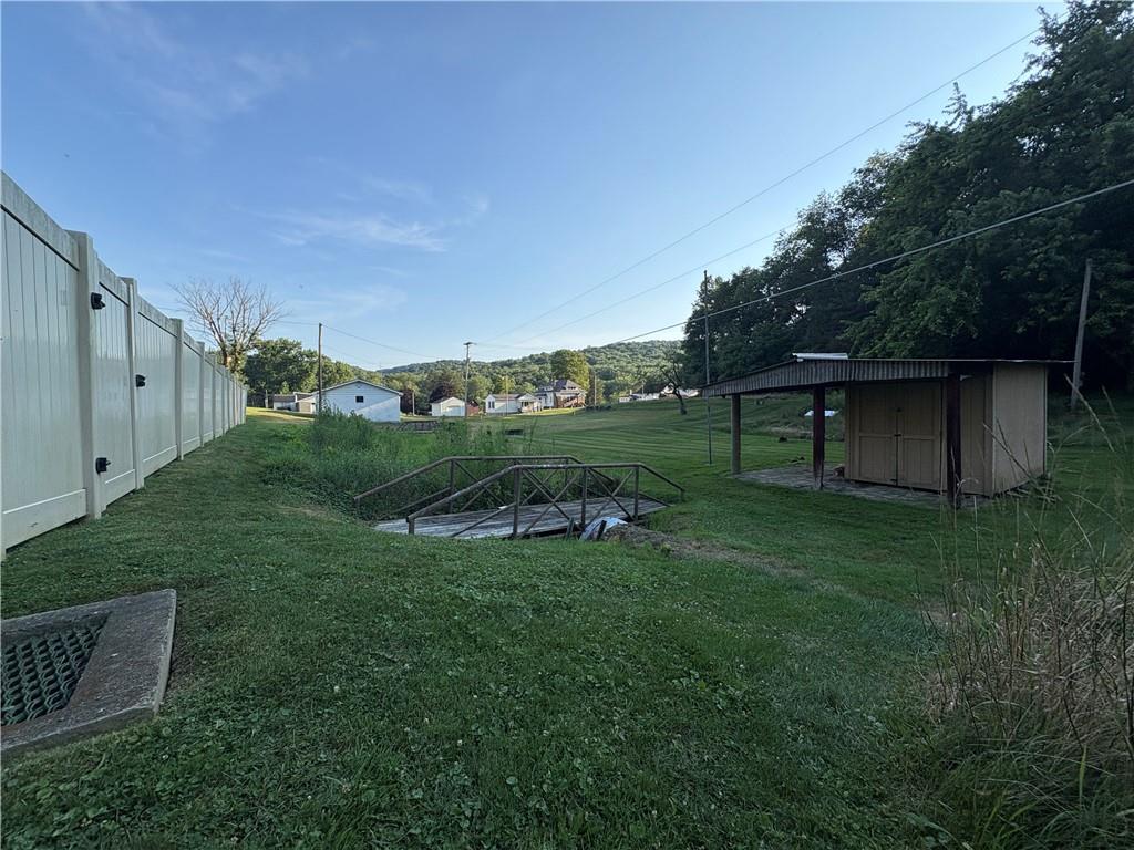 903 Clearfield Road Fenelton, PA 16034 - Photo 22 of 25 a view of a backyard with barn and green space