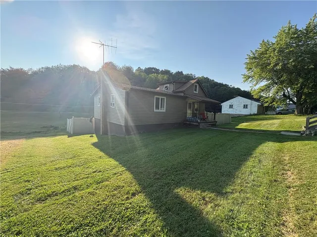 a view of a house with a garden and lake view