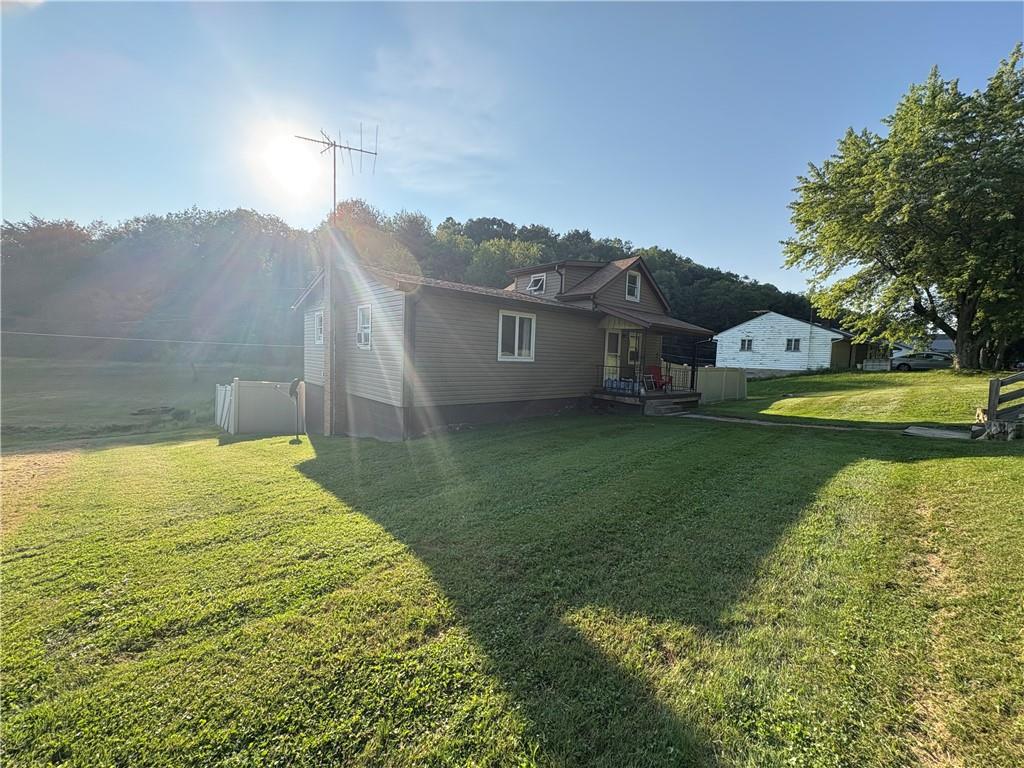 903 Clearfield Road Fenelton, PA 16034 - Photo 3 of 25 a view of a house with a garden and lake view