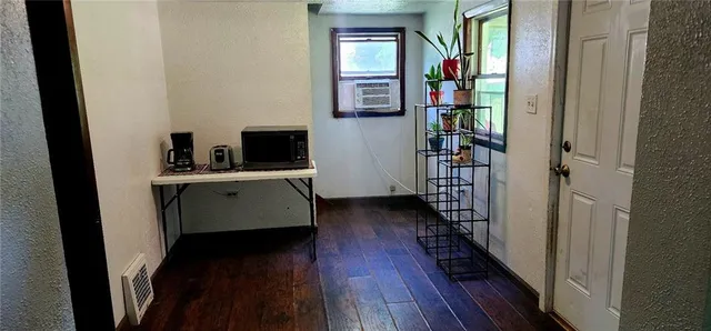 a view of a hallway with wooden floor and stairs