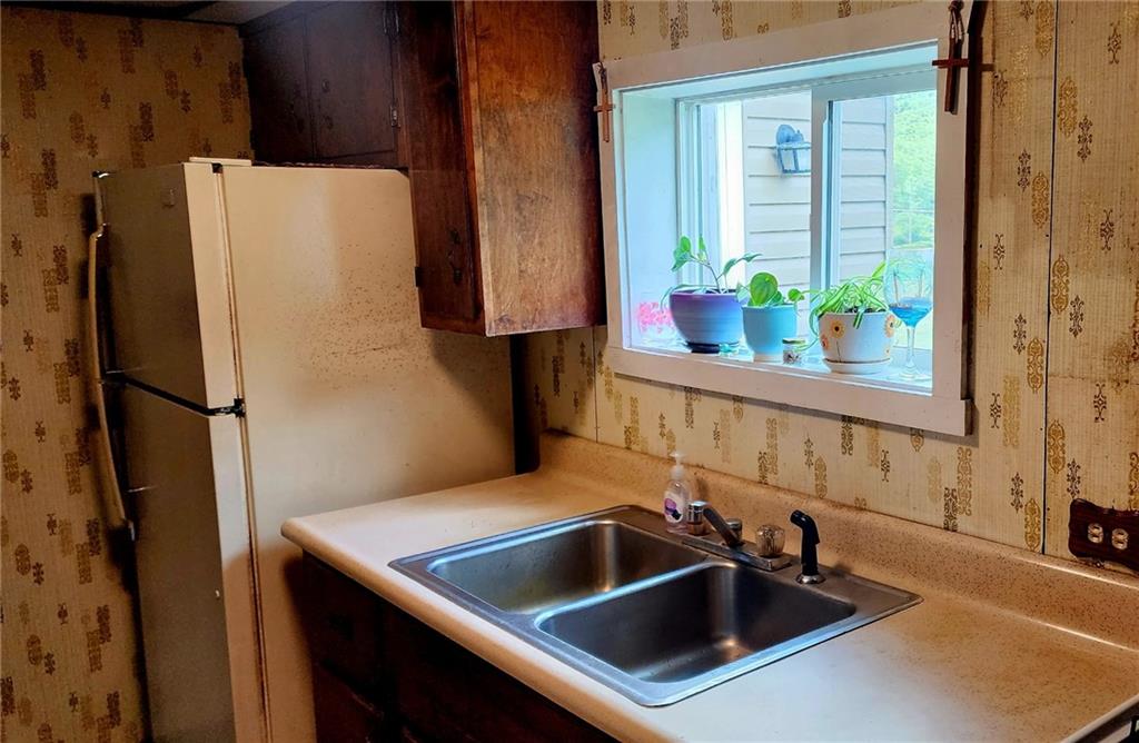903 Clearfield Road Fenelton, PA 16034 - Photo 10 of 25 a kitchen with a refrigerator and a sink