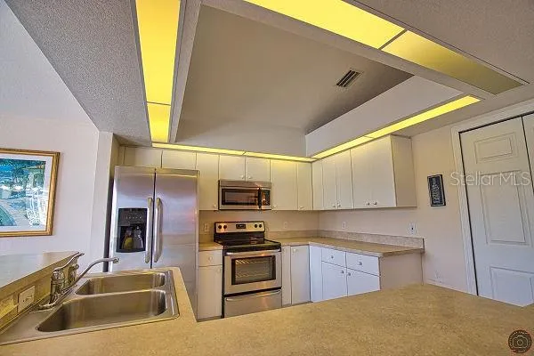 a kitchen with cabinets and sink