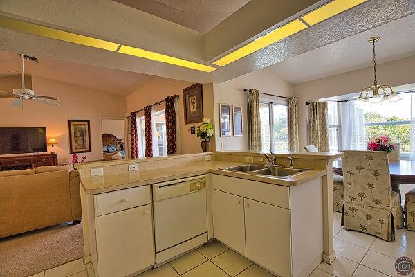 116 Albatross Road Rotonda West, FL 33947 - Photo 14 of 28 a kitchen with cabinets and sink