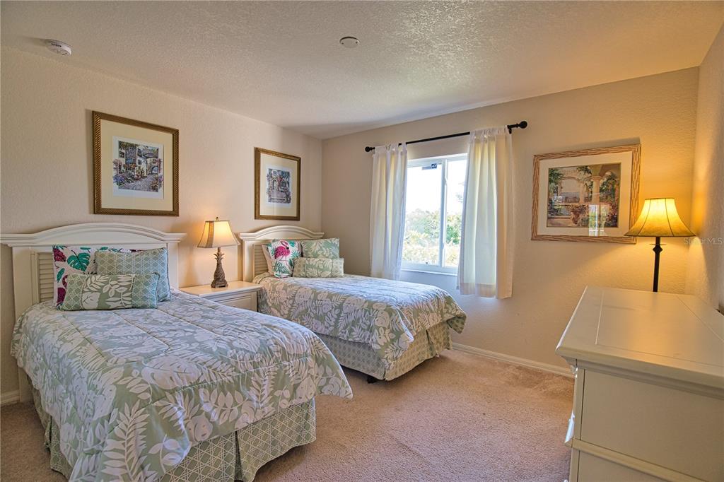 116 Albatross Road Rotonda West, FL 33947 - Photo 17 of 28 a bedroom with two beds and painting on the wall