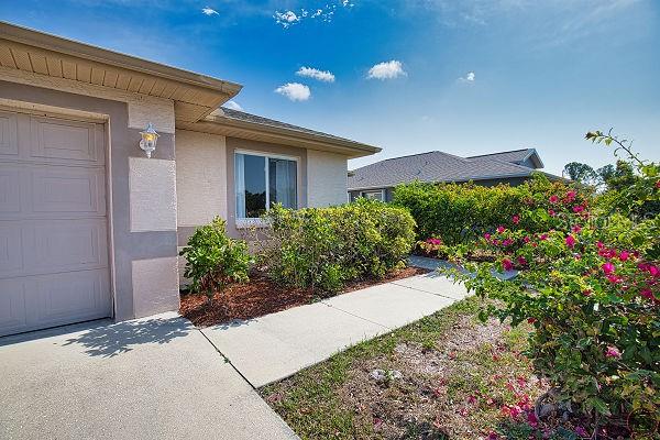 116 Albatross Road Rotonda West, FL 33947 - Photo 2 of 28 a view of a garden with potted plants