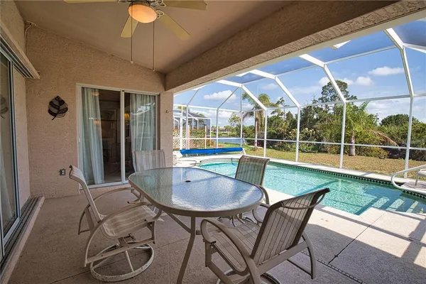 a view of backyard with swimming pool and outdoor seating