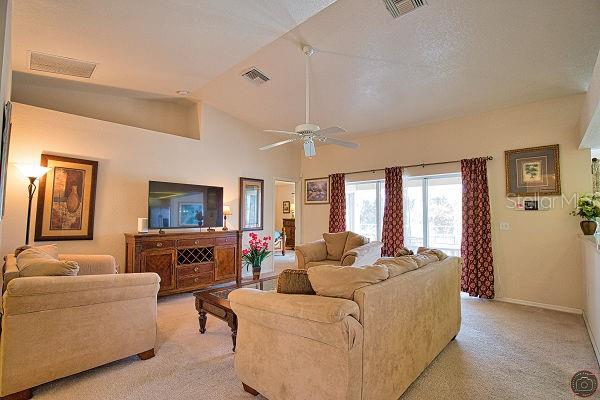 116 Albatross Road Rotonda West, FL 33947 - Photo 4 of 28 a living room with furniture flat screen tv and window