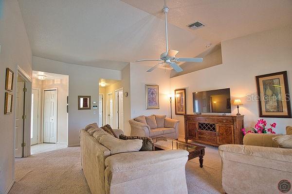 116 Albatross Road Rotonda West, FL 33947 - Photo 5 of 28 a living room with furniture and a flat screen tv
