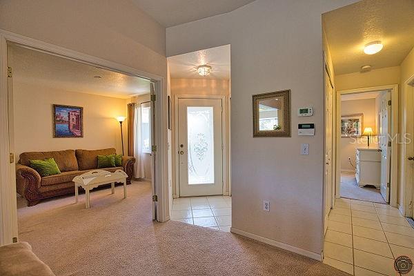 116 Albatross Road Rotonda West, FL 33947 - Photo 9 of 28 a living room with furniture and a walk in closet