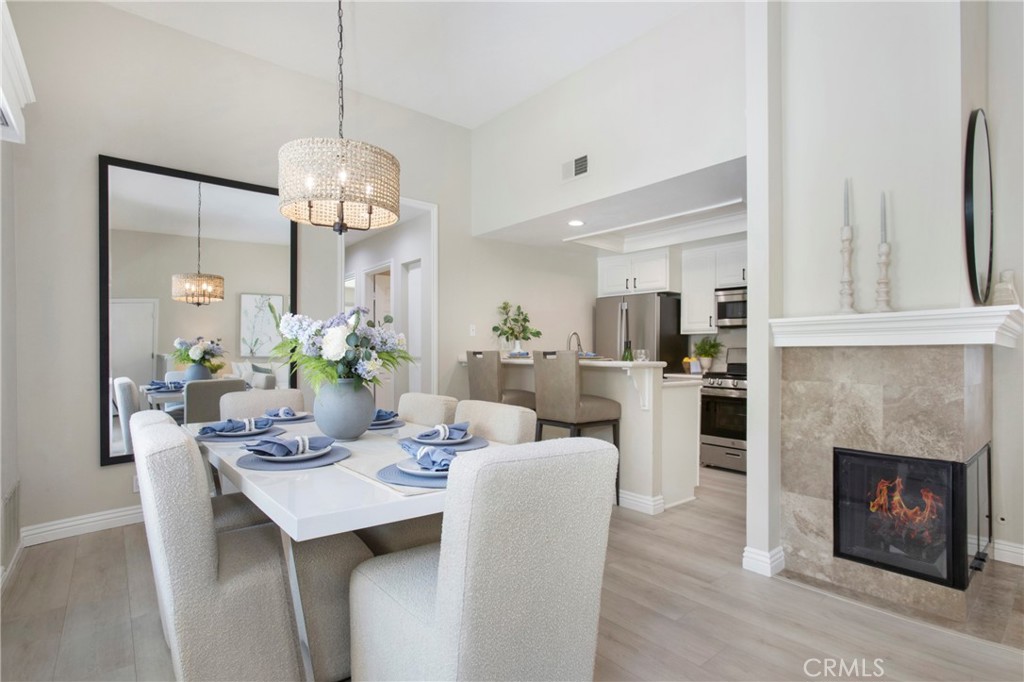 19 Spinnaker Irvine, CA 92614 - Photo 11 of 63 a dining room with furniture a chandelier and wooden floor