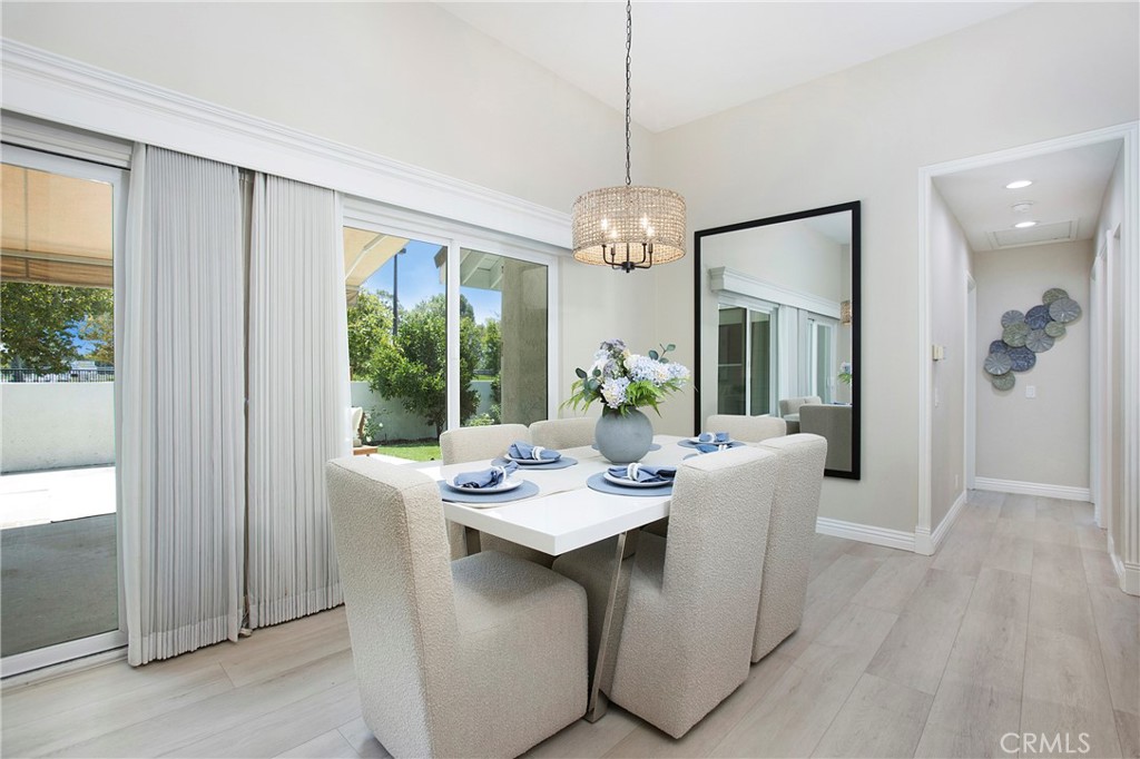 19 Spinnaker Irvine, CA 92614 - Photo 14 of 63 a dining room with furniture a chandelier and wooden floor