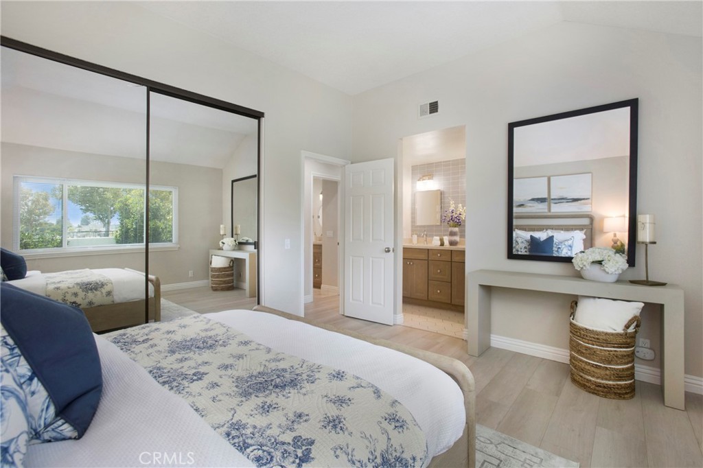 19 Spinnaker Irvine, CA 92614 - Photo 16 of 63 a spacious bedroom with a bed a mirror and a large window with balcony view