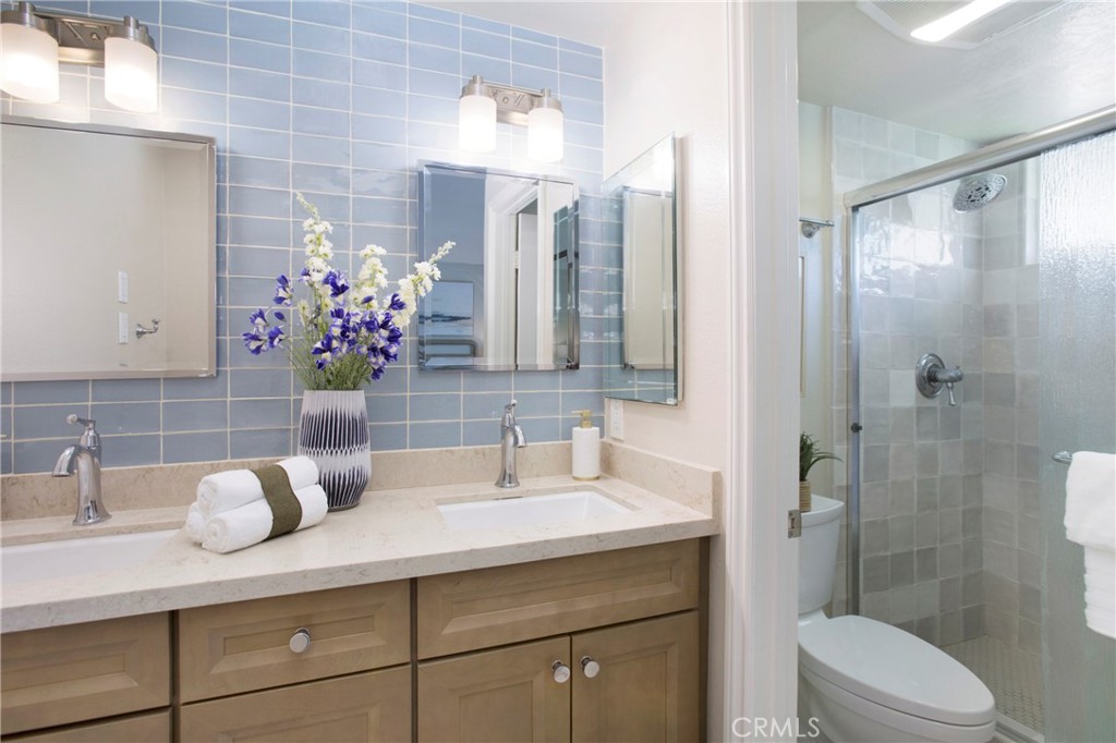 19 Spinnaker Irvine, CA 92614 - Photo 17 of 63 a bathroom with a granite countertop sink a toilet and shower