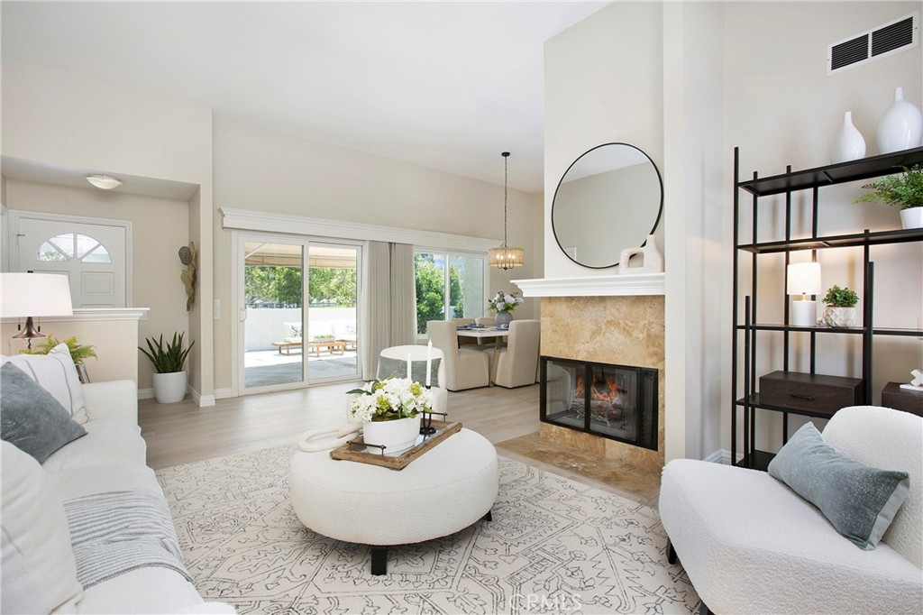 19 Spinnaker Irvine, CA 92614 - Photo 8 of 63 a living room with furniture a fireplace a large window and a fireplace