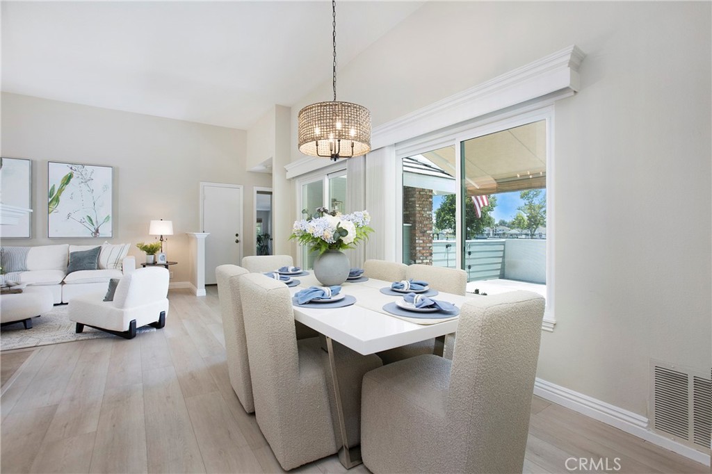 19 Spinnaker Irvine, CA 92614 - Photo 10 of 63 a dining room with furniture a livingroom view and wooden floor