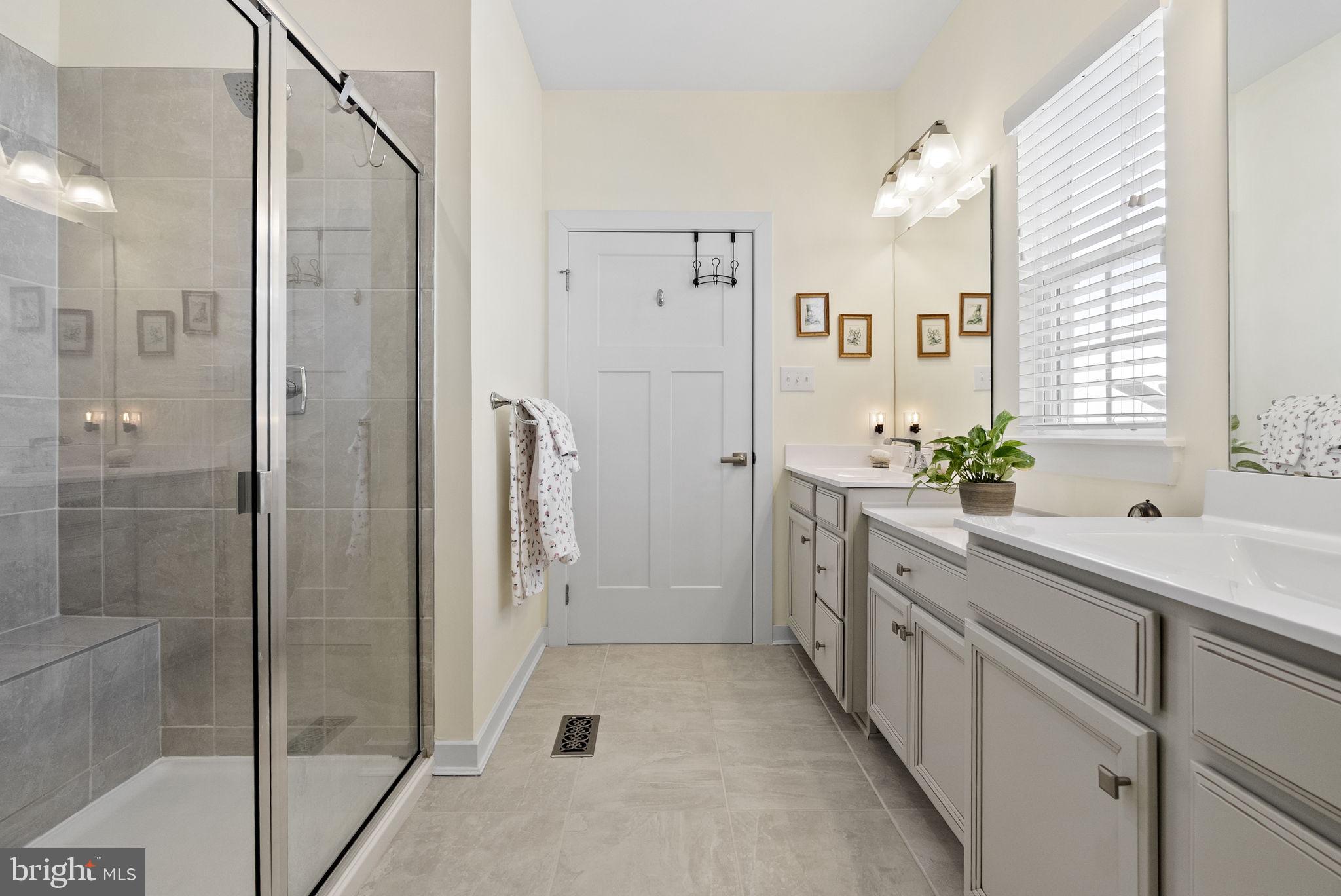 112 Frame Drive Coatesville, PA 19320 - Photo 29 of 55 a spacious bathroom with a shower sink and mirror