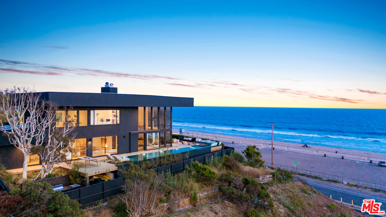 6463 Surfside Way Malibu, CA 90265 - Photo 2 of 31 a front view of a building with a yard