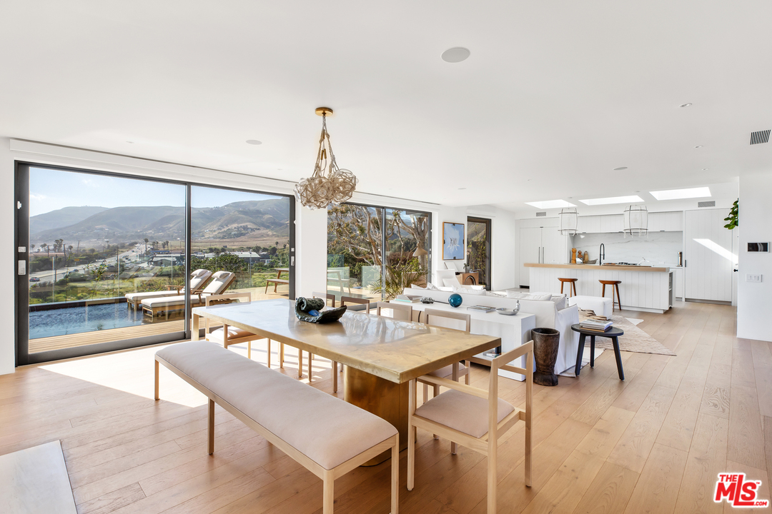 6463 Surfside Way Malibu, CA 90265 - Photo 13 of 31 a very nice looking living room with a large window and dining table