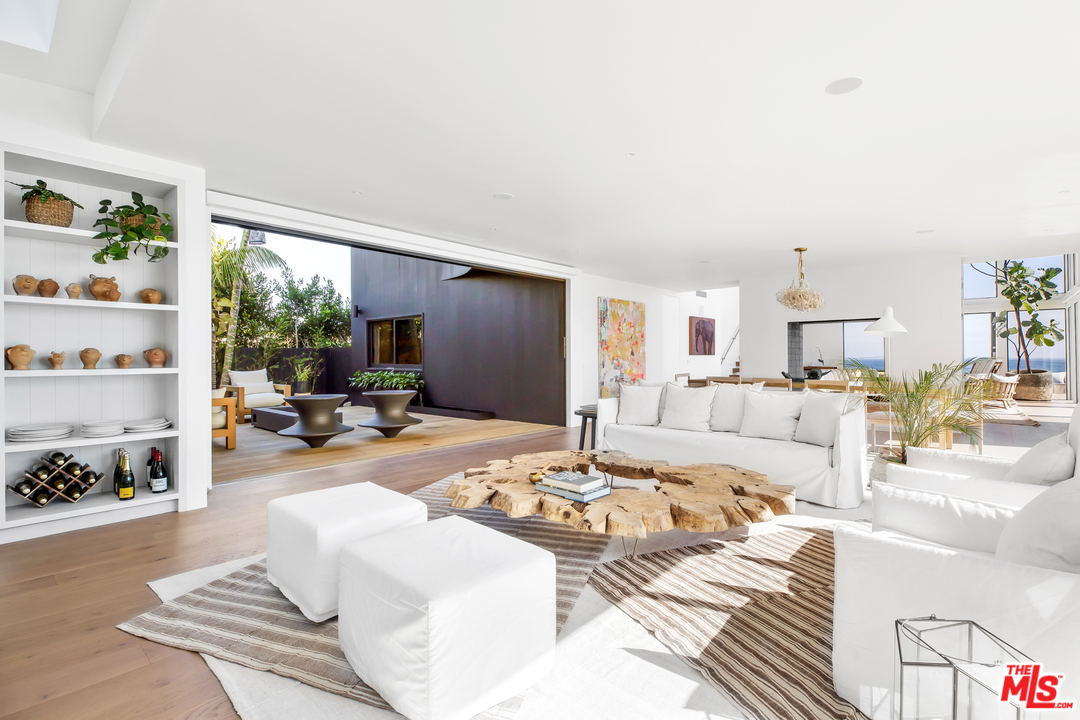 6463 Surfside Way Malibu, CA 90265 - Photo 16 of 31 a living room with furniture fireplace and a window
