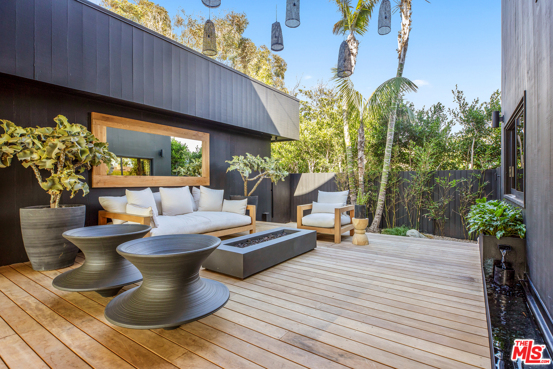 6463 Surfside Way Malibu, CA 90265 - Photo 17 of 31 a view of a patio with chairs and potted plants