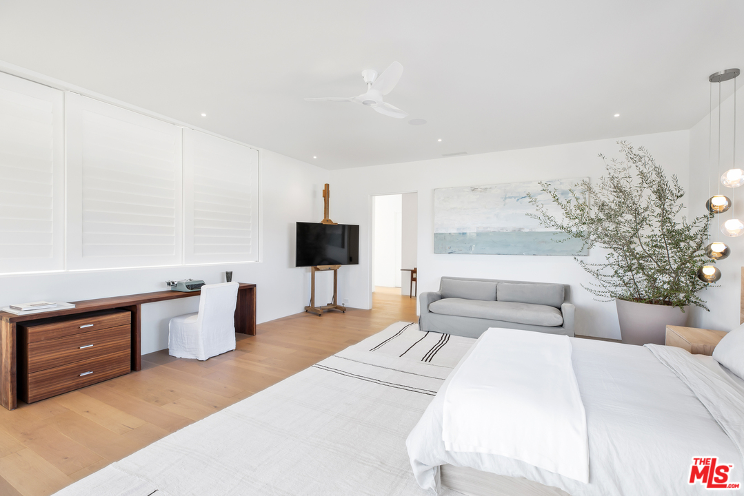 6463 Surfside Way Malibu, CA 90265 - Photo 25 of 31 a bedroom with a large bed and a flat tv screen on dresser