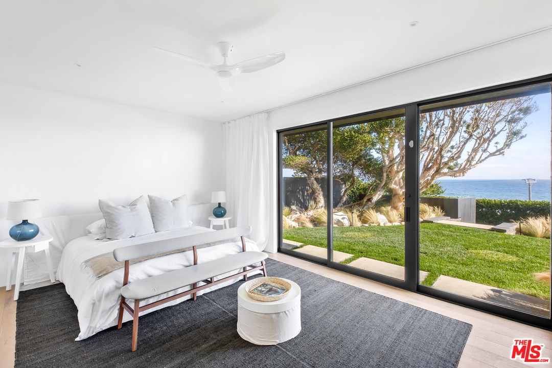 6463 Surfside Way Malibu, CA 90265 - Photo 31 of 31 a bedroom with a bed and large window