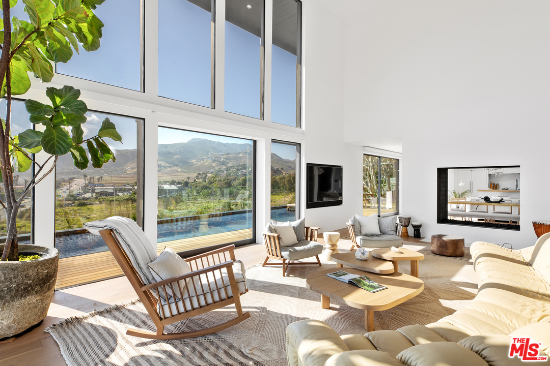 6463 Surfside Way Malibu, CA 90265 - Photo 7 of 31 a living room with patio furniture and a potted plant