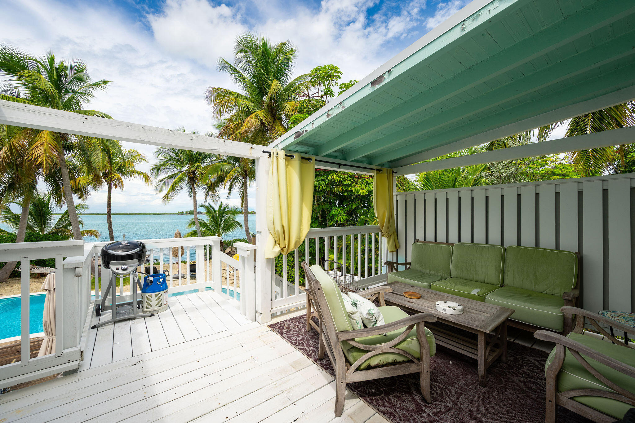 78 Bay Drive Key West, FL 33040 - Photo 38 of 116 a view of a deck with furniture and a backyard