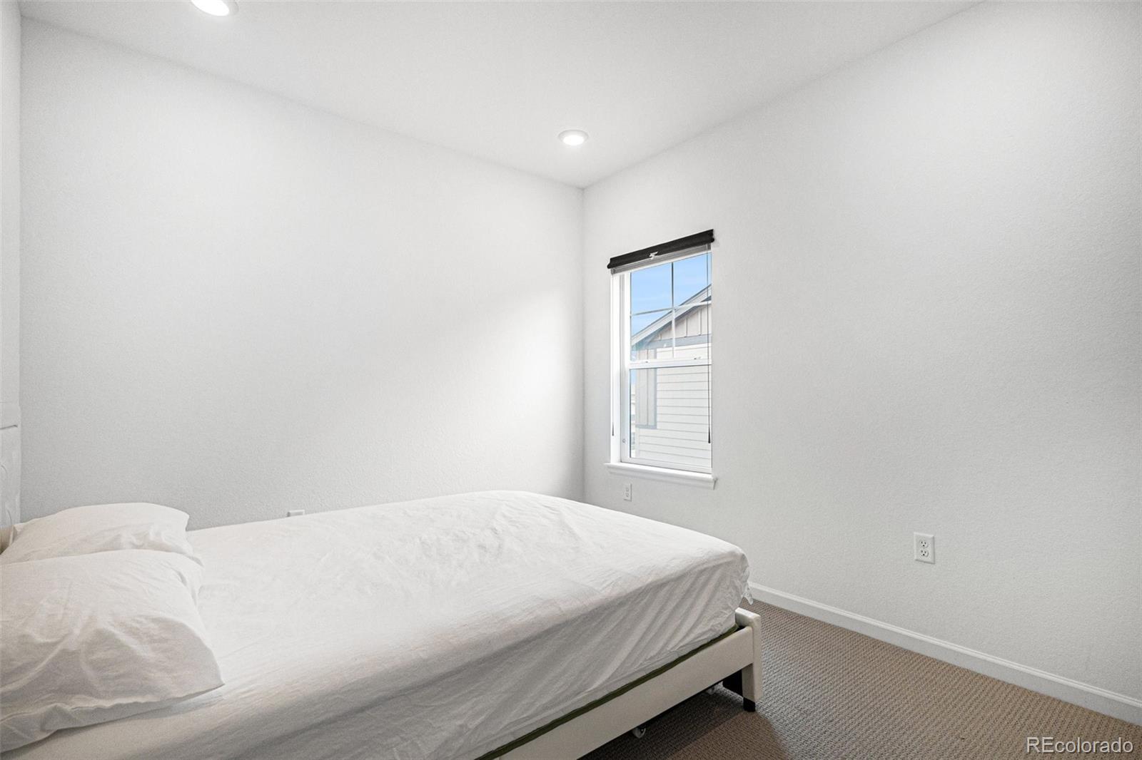 18235 Caffey Drive Parker, CO 80134 - Photo 16 of 38 a bedroom with a bed and a window
