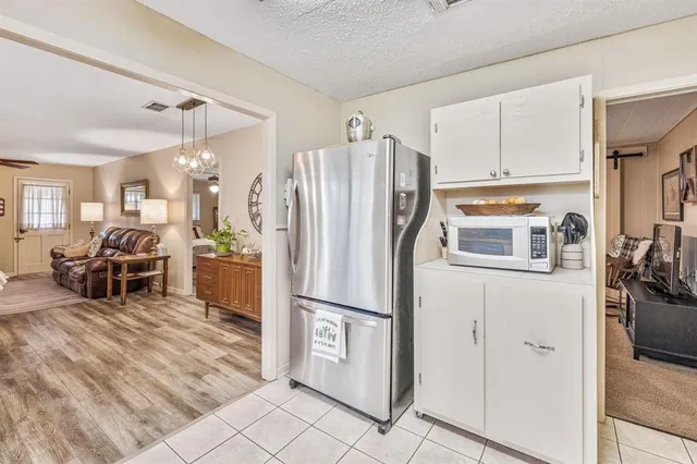 a kitchen with stainless steel appliances a refrigerator and microwave
