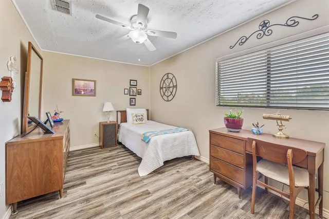 a bedroom with a bed and a dresser in it