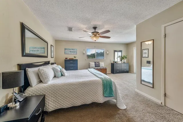 a bedroom with furniture and a ceiling fan