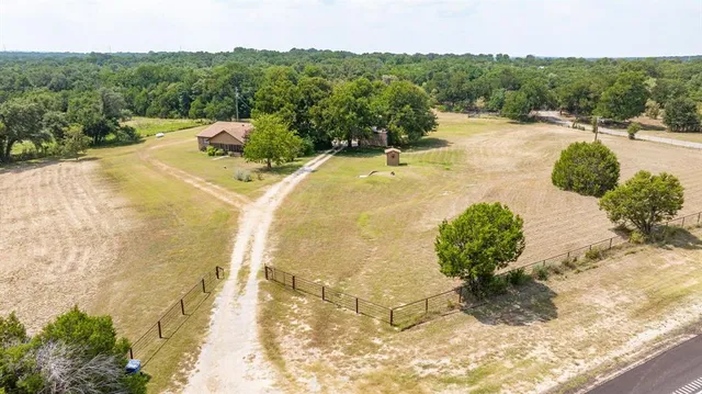 an aerial view of a house with a lake view