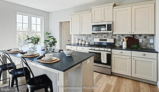 a kitchen with a sink stove and white cabinets