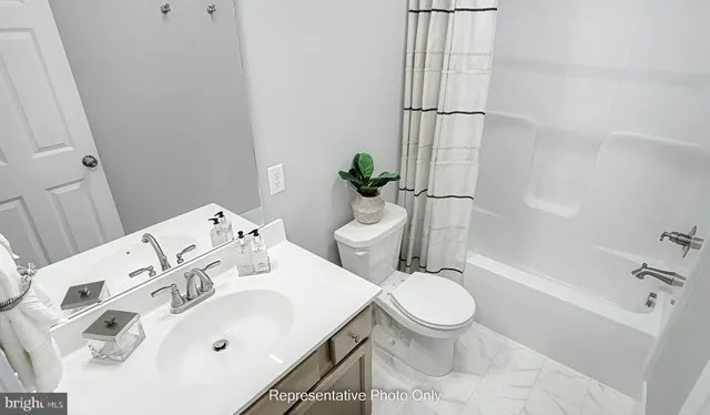 a white toilet sitting next to a bathroom sink