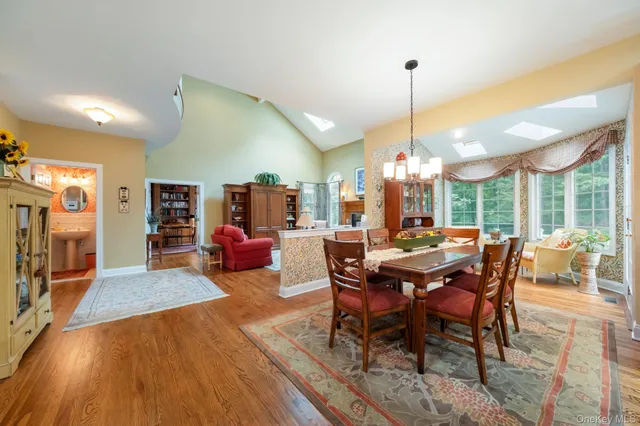 a view of a dining room with furniture window and wooden floor