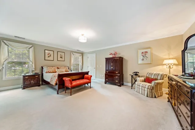 a bedroom with furniture and a large window