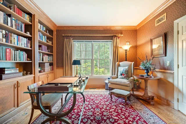 a living room with furniture and a book shelf