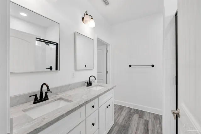 a bathroom with a glass shower door