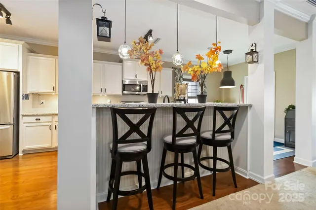 a dining room filled with furniture and chandelier