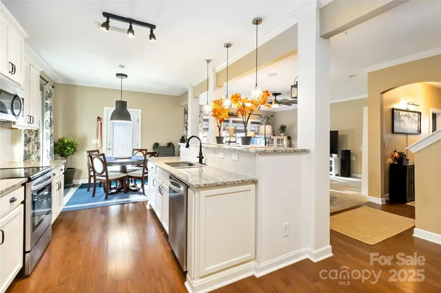 a kitchen with stainless steel appliances granite countertop a stove and cabinets