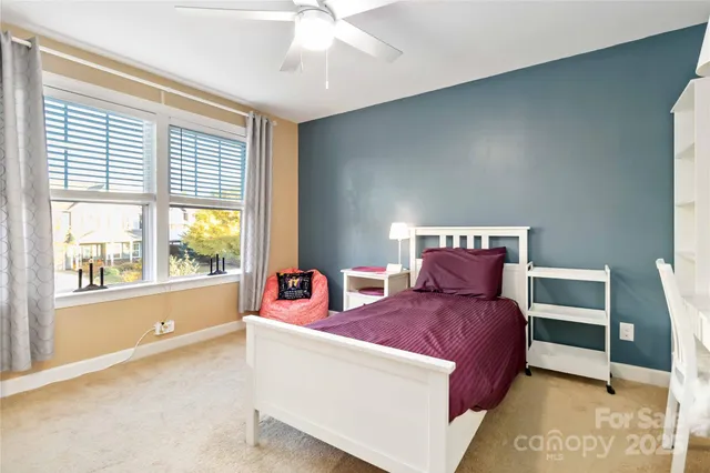 a bedroom with a large bed and a large window