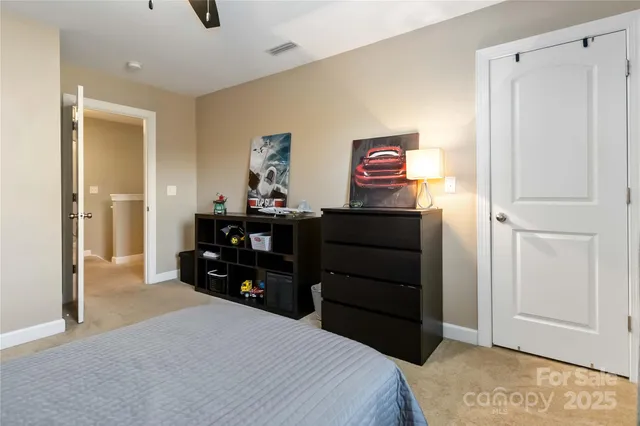a bedroom with a bed and a dresser
