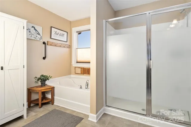 a bathroom with a tub and shower