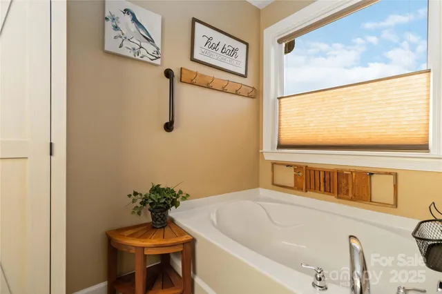 a bathroom with a tub and a window