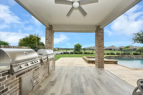 a view of a patio with wooden floor and iron stairs