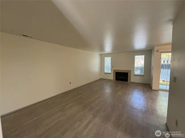 a view of empty room with a fireplace