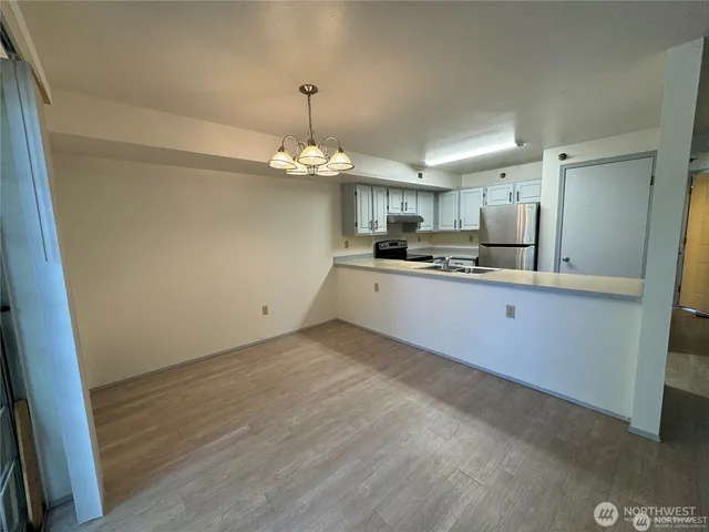 a kitchen with kitchen island a sink stainless steel appliances and cabinets