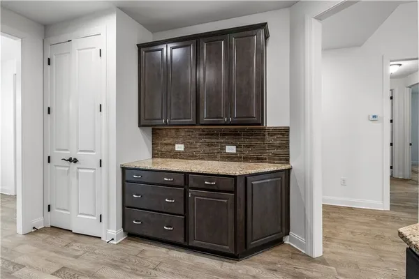 a view of cabinets with granite countertop wooden cabinets