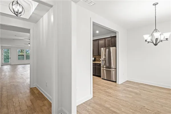 a view of kitchen with granite countertop wooden cabinets stainless steel appliances and a window
